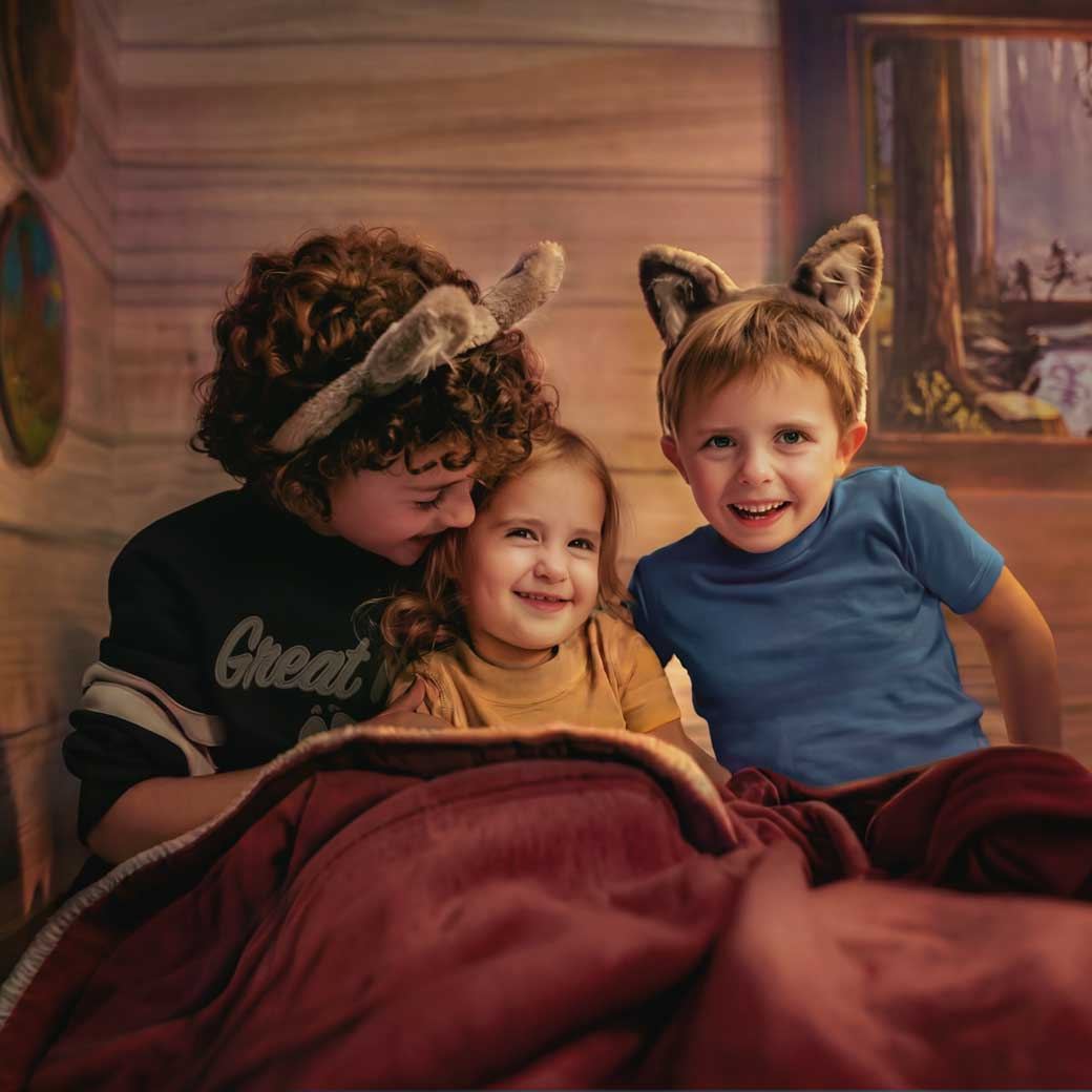 Two kids reading together on a bunk bed in a themed hotel suite