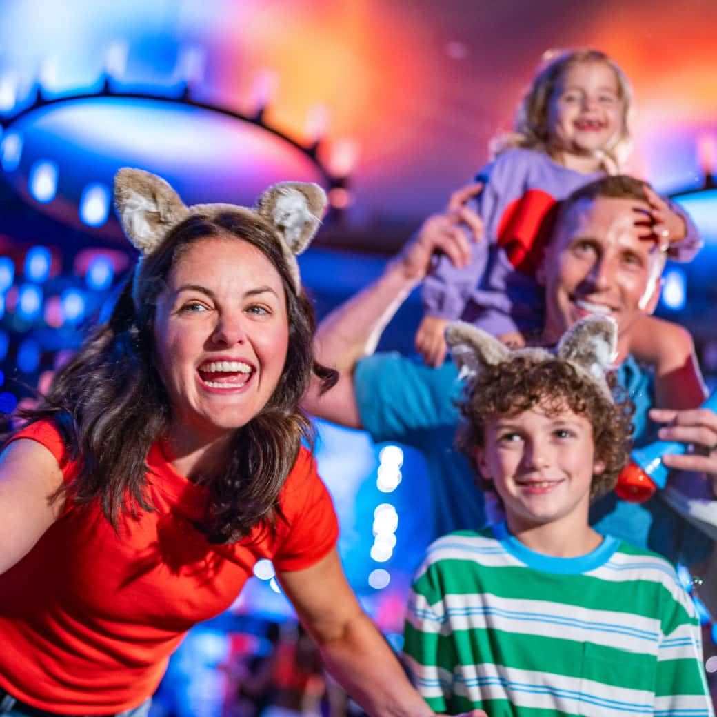 Family enjoying a glow-in-the-dark dance party wearing wolf ear headbands