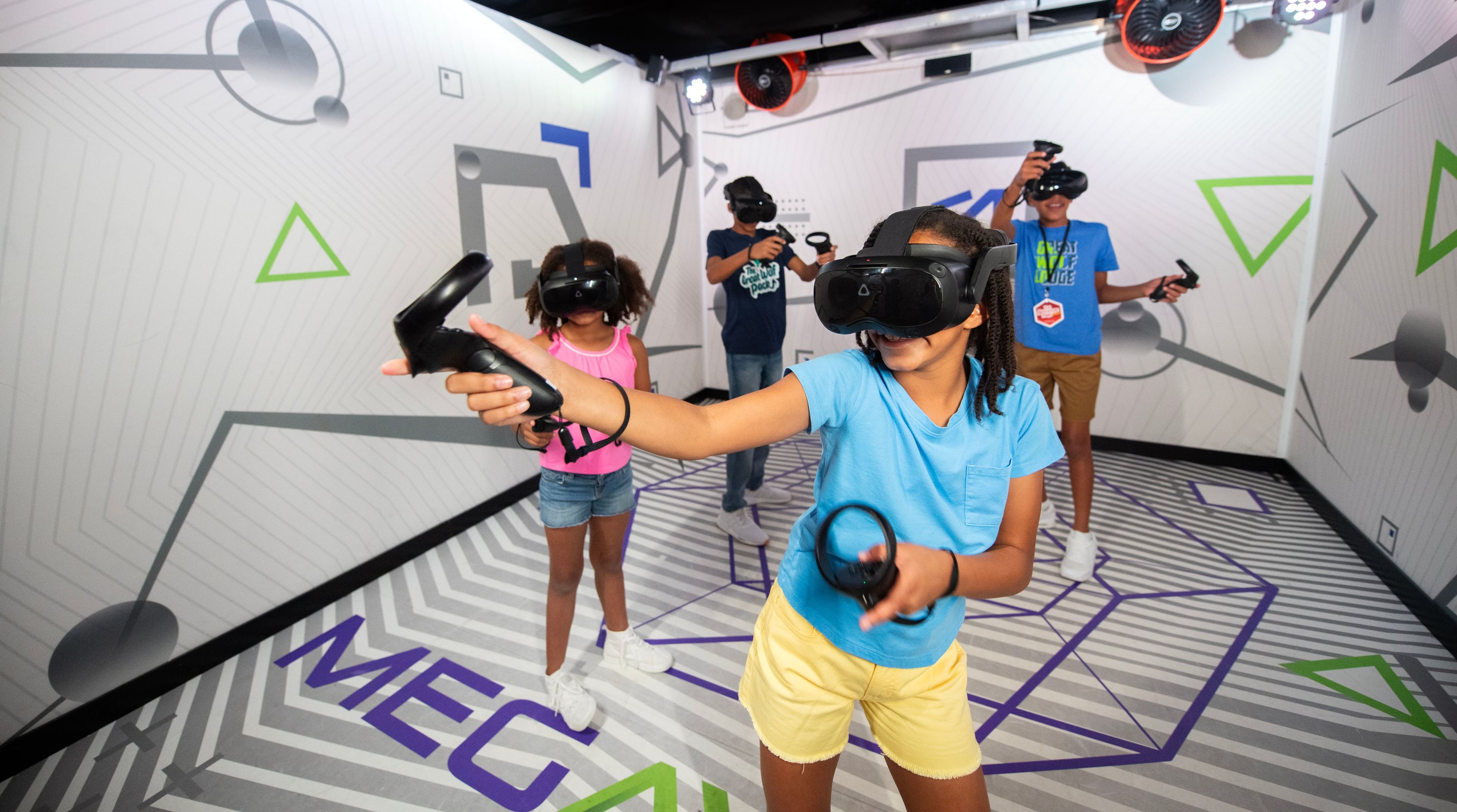 Kids wearing VR headsets playing The Virtual Frontier arcade game